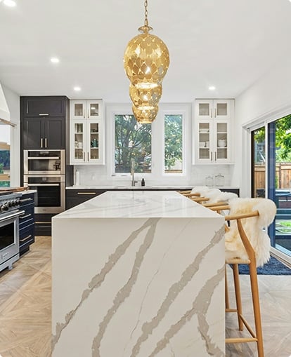 white and black themed kitchen featuring white marble countertops.