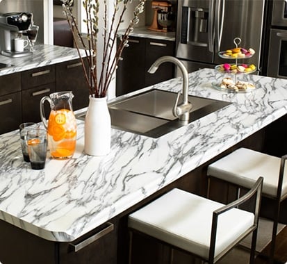 black themed kitchen featuring white marble countertops.